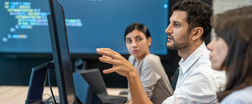 IT professionals analyzing cybersecurity threats in modern office