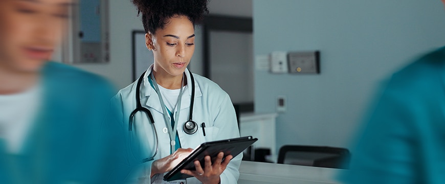 banner image of a doctor reviewing patient data on a tablet