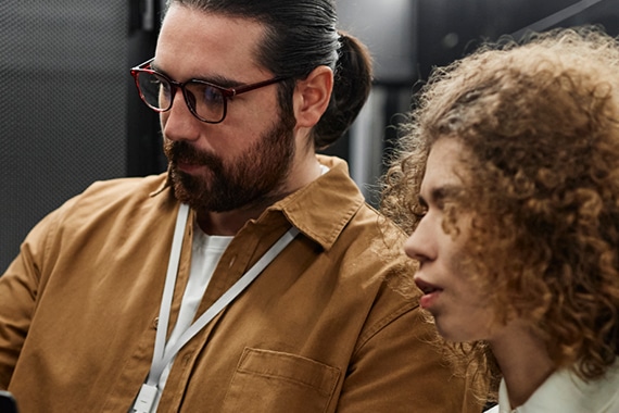 lifestyle image of two IT specialists working inside a data center