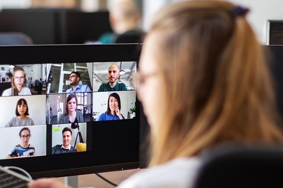 lifestyle image of a woman working in an office while on a video conference call