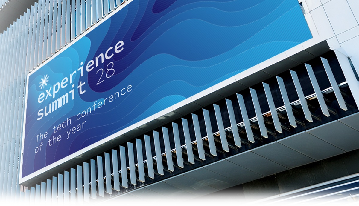 Outdoor digital display on a modern glass building facade.