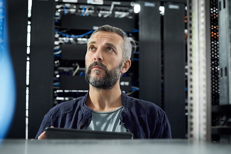 Image of an IT specialist working in a server room