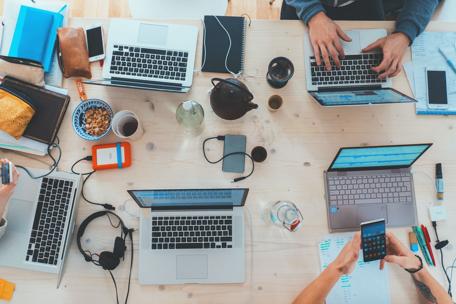 People sitting in front of a computers working in an office setting.