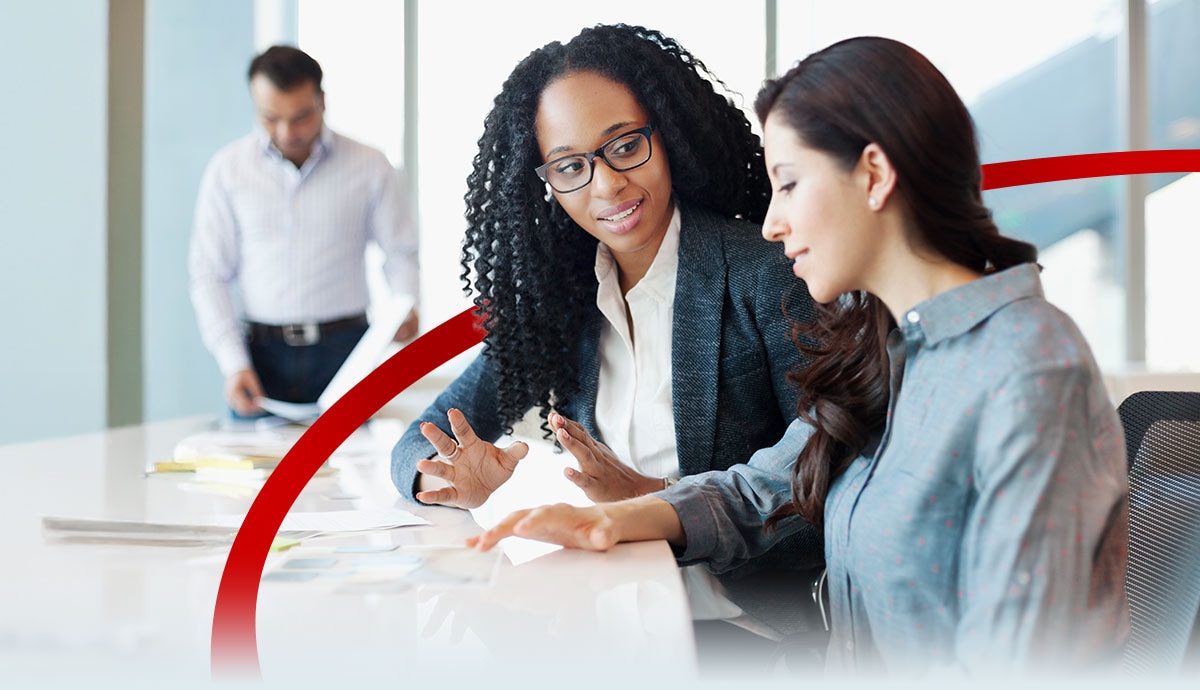 Woman discussing ideas with colleague at meeting table