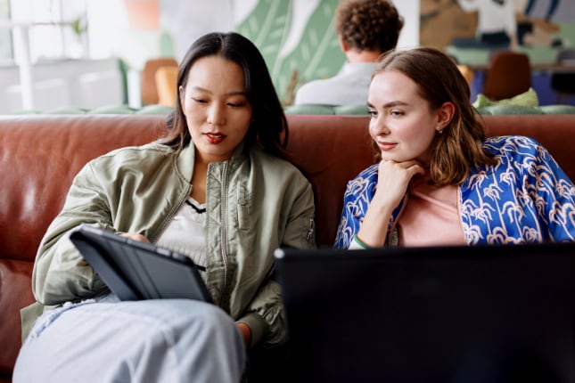 Two businesswomen working together in a modern office.