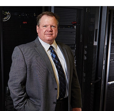 Craig Huss stands in a data center