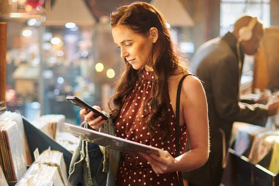 Women shopping in a store with her phone.