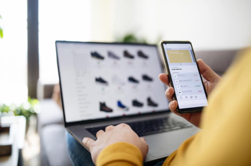 Man shopping online with his laptop and phone.