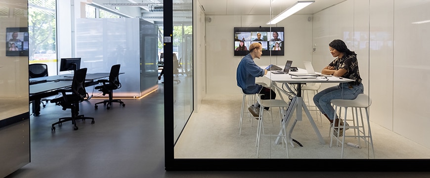 image of employees working inside a modern workplace environment