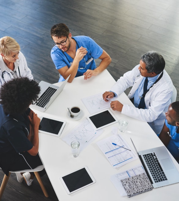 Healthcare workers having a conversation around a table.