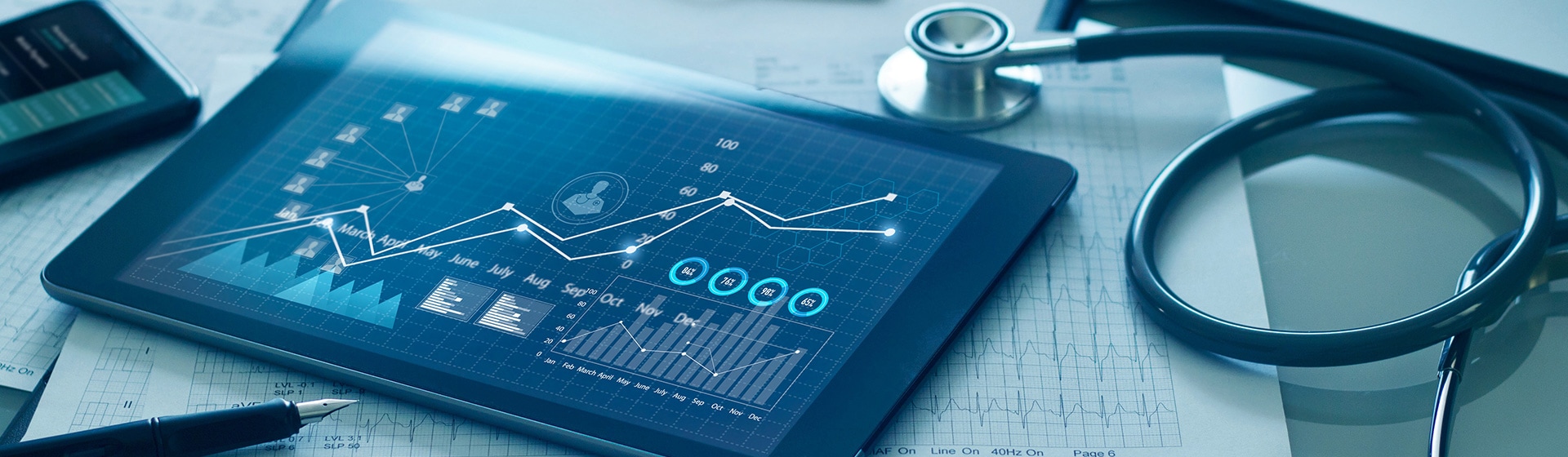 Tablet device and stethoscope sitting on desk.