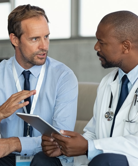 IT guy talking with male doctor.