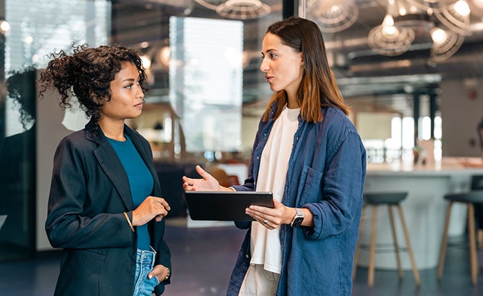 Two professionals collaborating in a modern office, symbolizing CDW’s Salesforce-certified expertise and strategic partnerships that maximize ROI and business success.