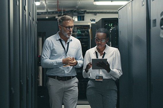 two IT specialists working in a data center.