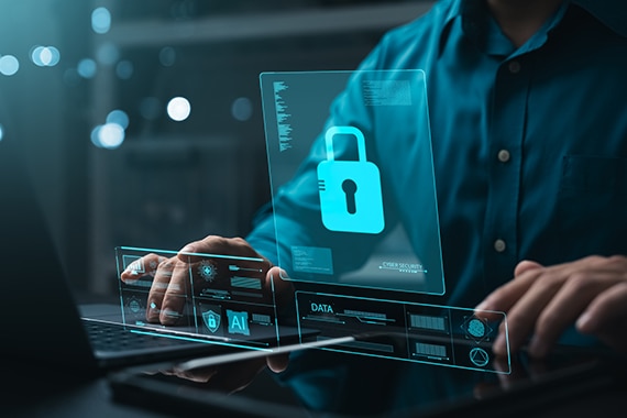 image of a cybersecurity specialist working on program assessment from a laptop computer.