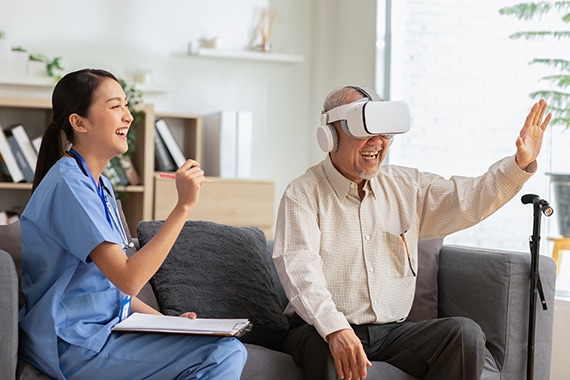 Female doctor giving advice to elderly patient using VR or Virtual Reality glasses headset 