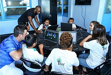 Chris Paul and Gary Woodland help children to use Lenovo's Tech Fore! donation