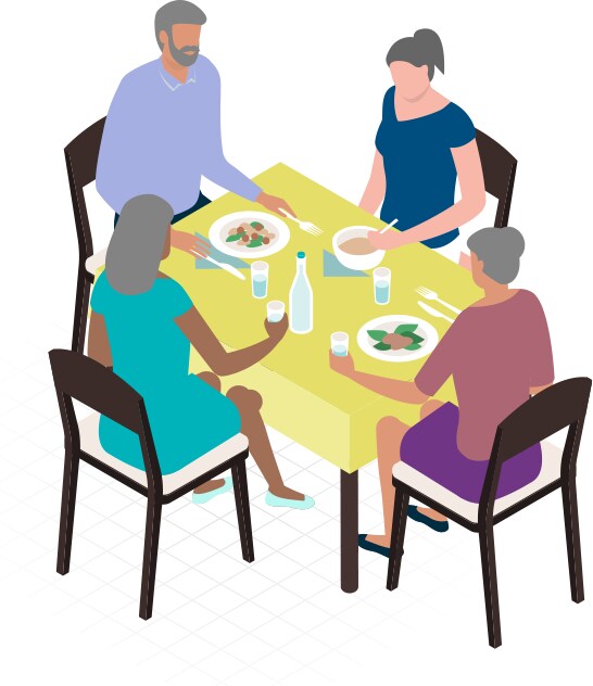Image of people at a table eating food.