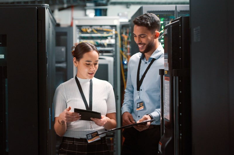 IT specialists working together in a server room.