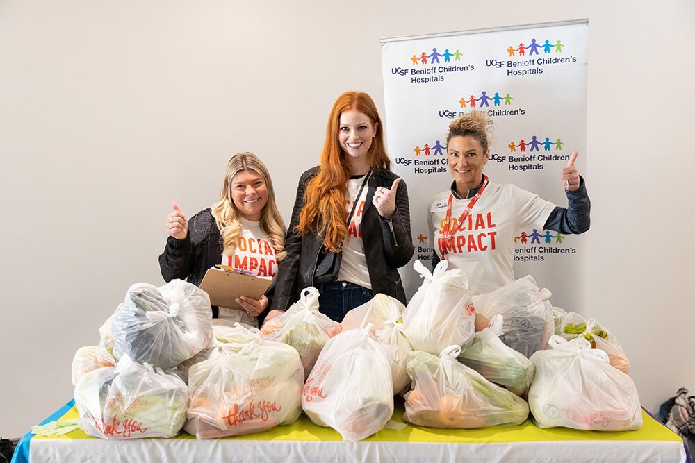 CDW coworkers behind donated food wearing social impact t-shirts