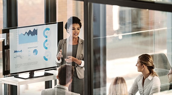 Image of a woman presenting at an office