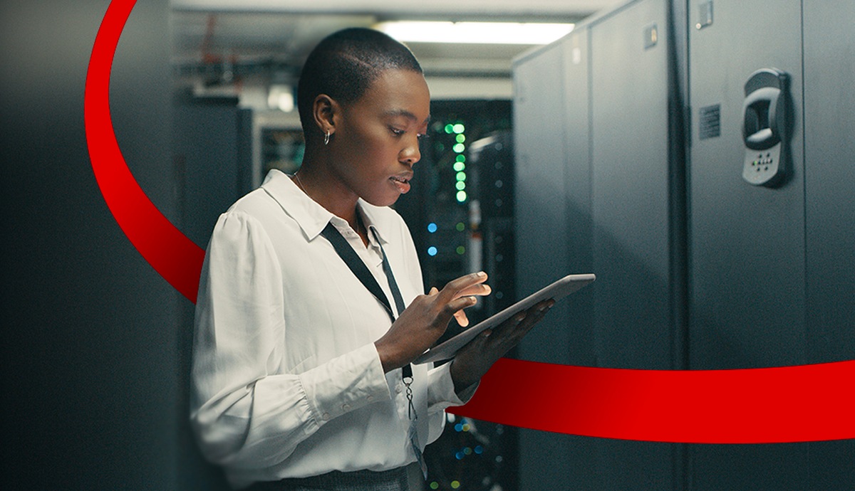 Government employee working on tablet in data center.