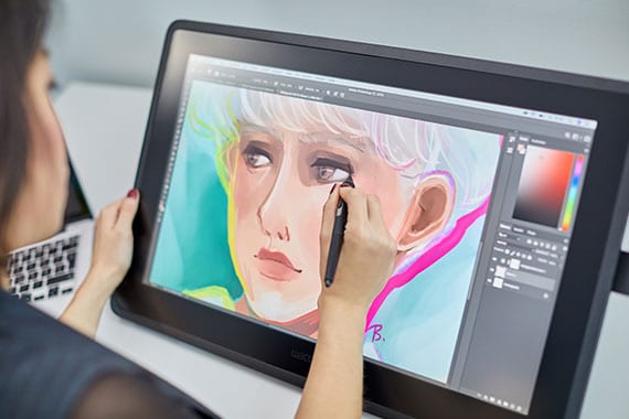 Woman drawing on Wacom Tablet with Pen