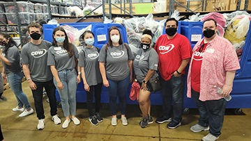 Chicago-based CDW coworkers pose in front of blue donation bins