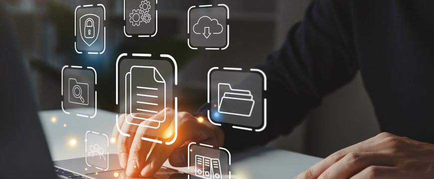 Person using a laptop with floating digital document management icons