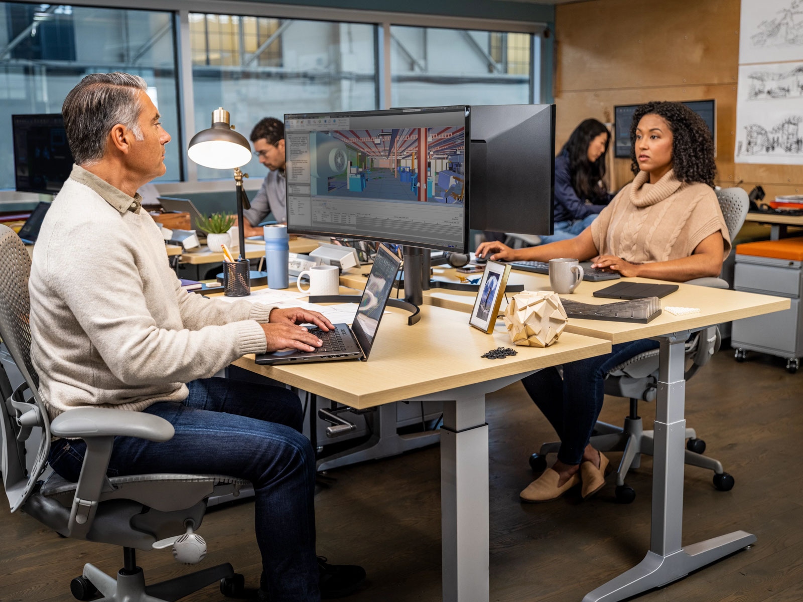 People working at an engineering firm using autodesk autocad to create architectural visualisations.