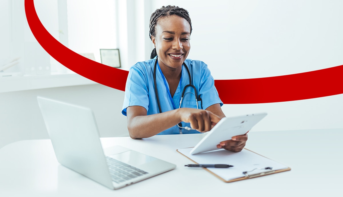 Nurse using tablet in hospital.