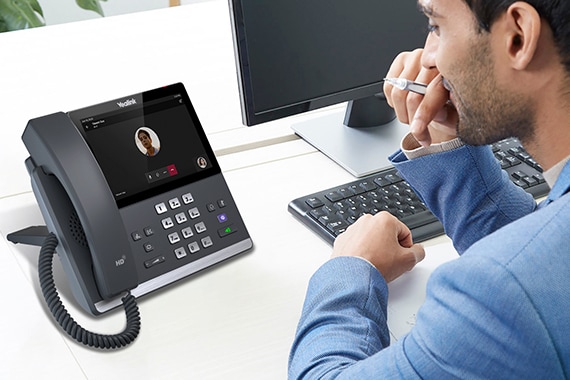 image of a man on a conference call with a speaker phone system