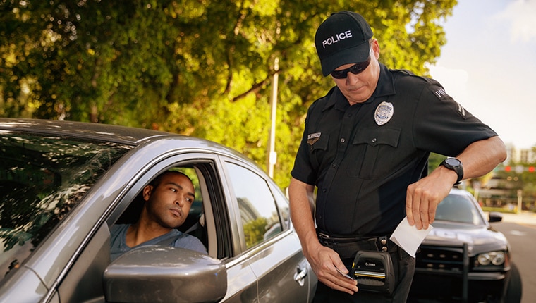 image of a police officer issuing a ticket to a driver using Zebra Technologies